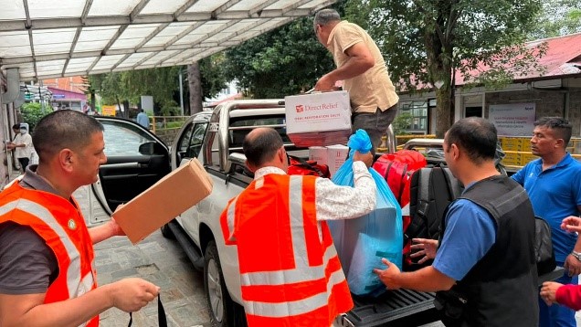 A medical team from Dhulikhel Hospital loads a truck with emergency aid from Direct Relief for deployment to flooded communities.